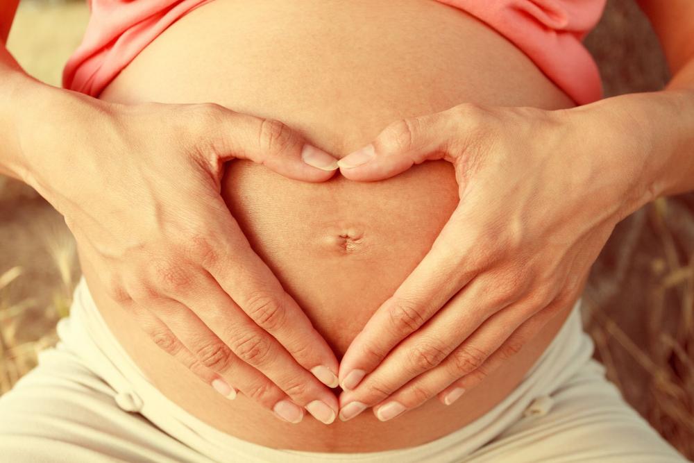 20469963 - pregnant woman making heart shape with her hands